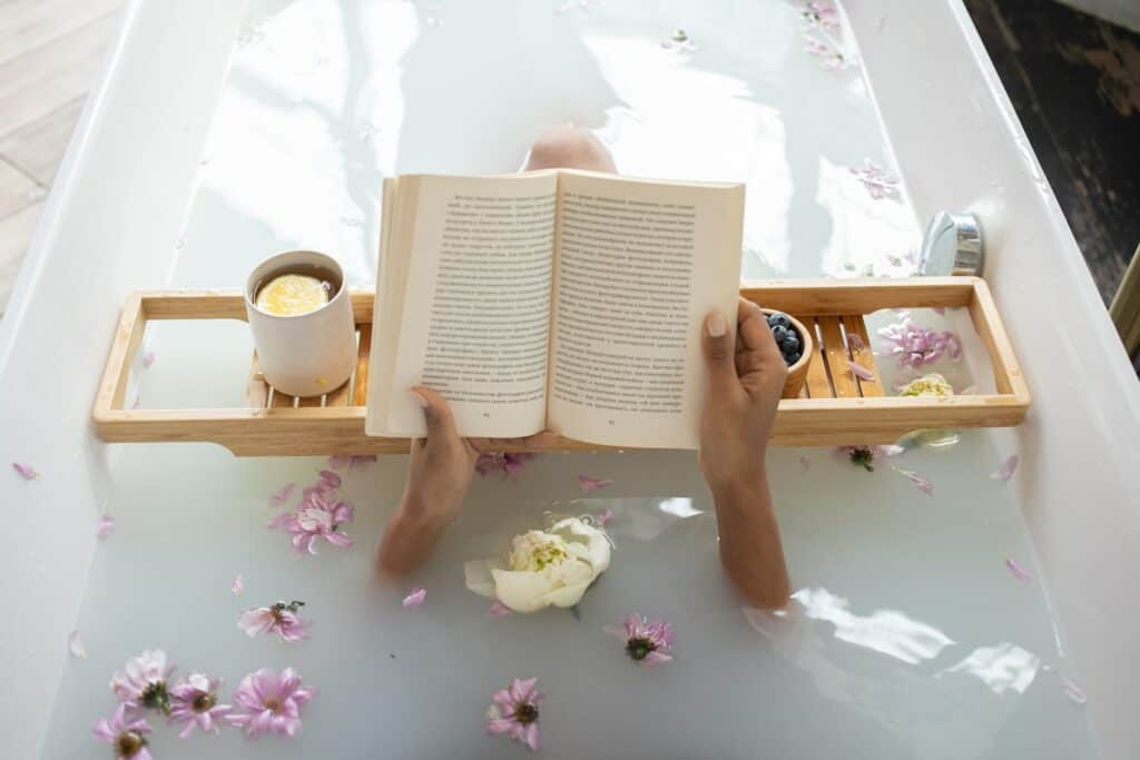 Woman in bath with tea coffee rose petals