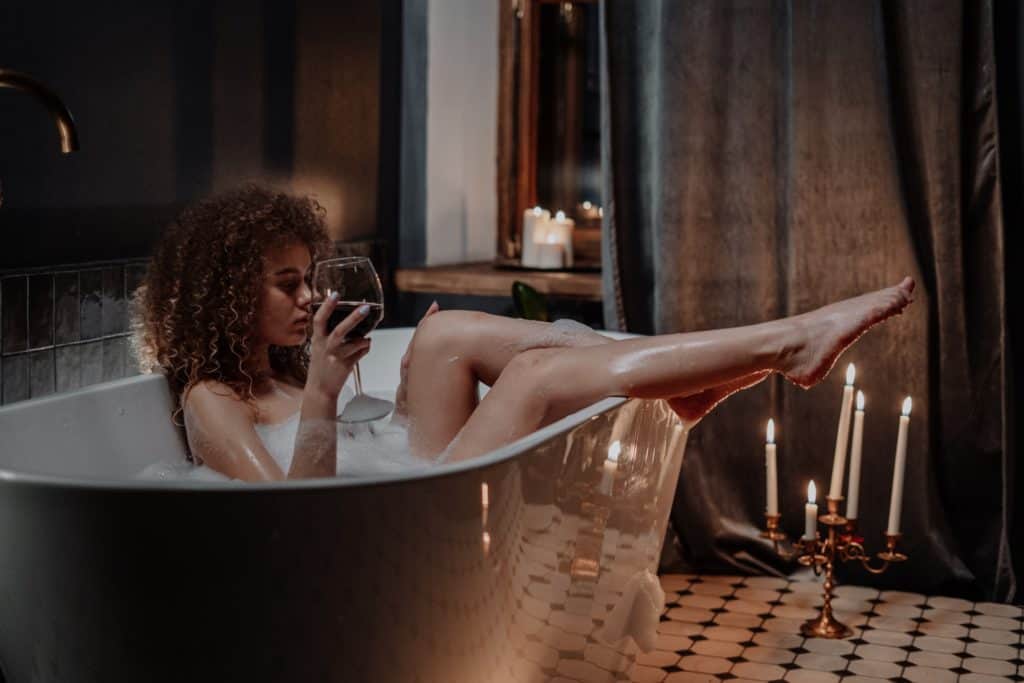 Squatting Woman In Bath Tub With Red Wine