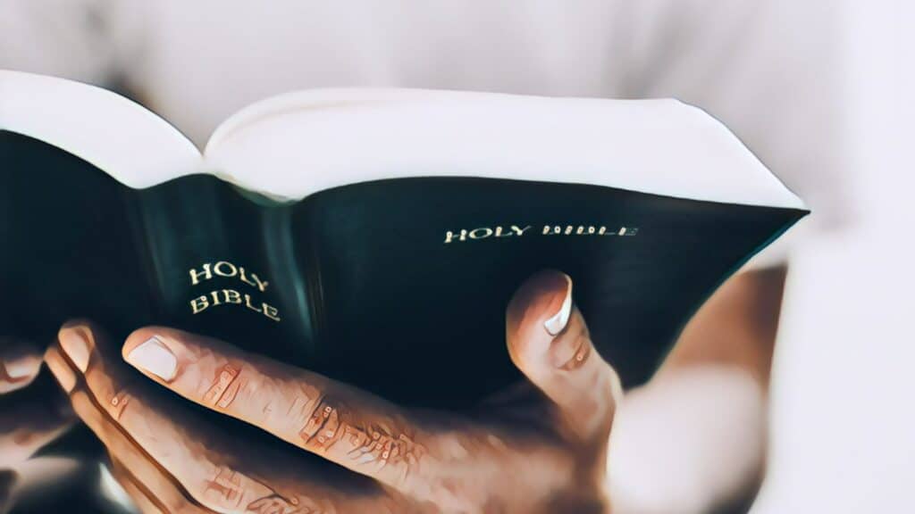 The Importance Of Financial Freedom - man holding reading the holy bible