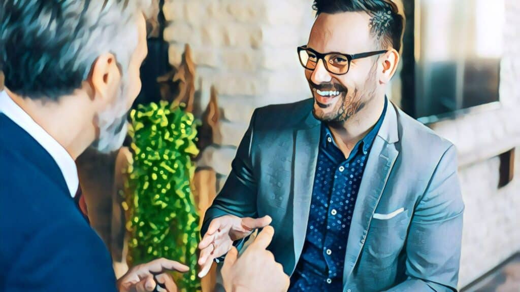 11 Ways To Buy Your First Rental Property partners business men suits smiling meeting shaking hands glasses beard gray beard gray