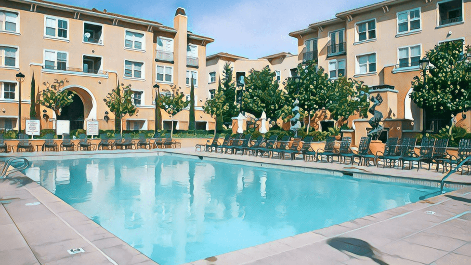 Ultimate Guide to California Real Estate Investing - San Jose apartment complex, outdoor swimming pool, day time, lounge chairs surround pool, trees surround perimeter of pool area, beige apartment building, sandstone